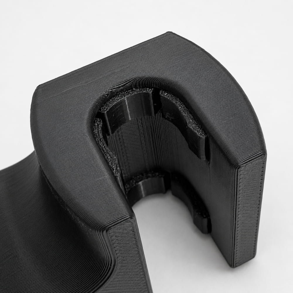 Black 3D-printed object on a white background