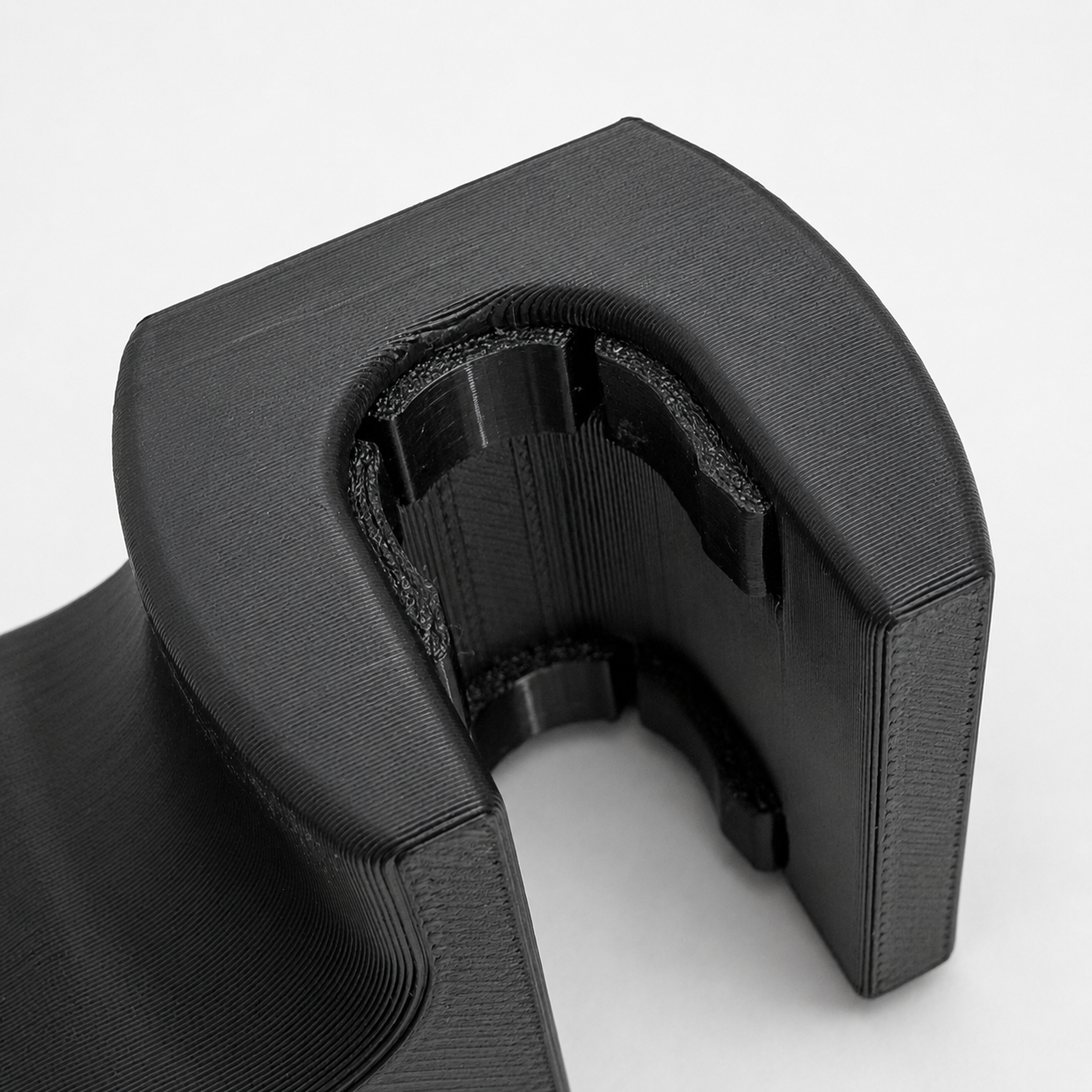 Black 3D-printed object on a white background