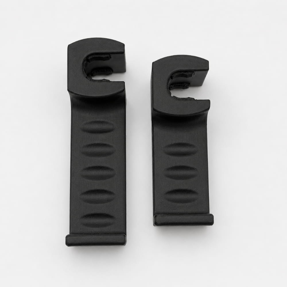 Two black plastic clips on a white background
