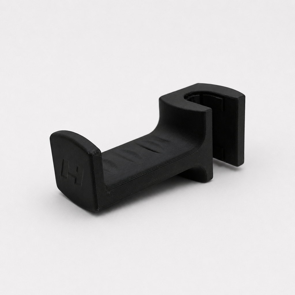 Black plastic headrest hook on a white background