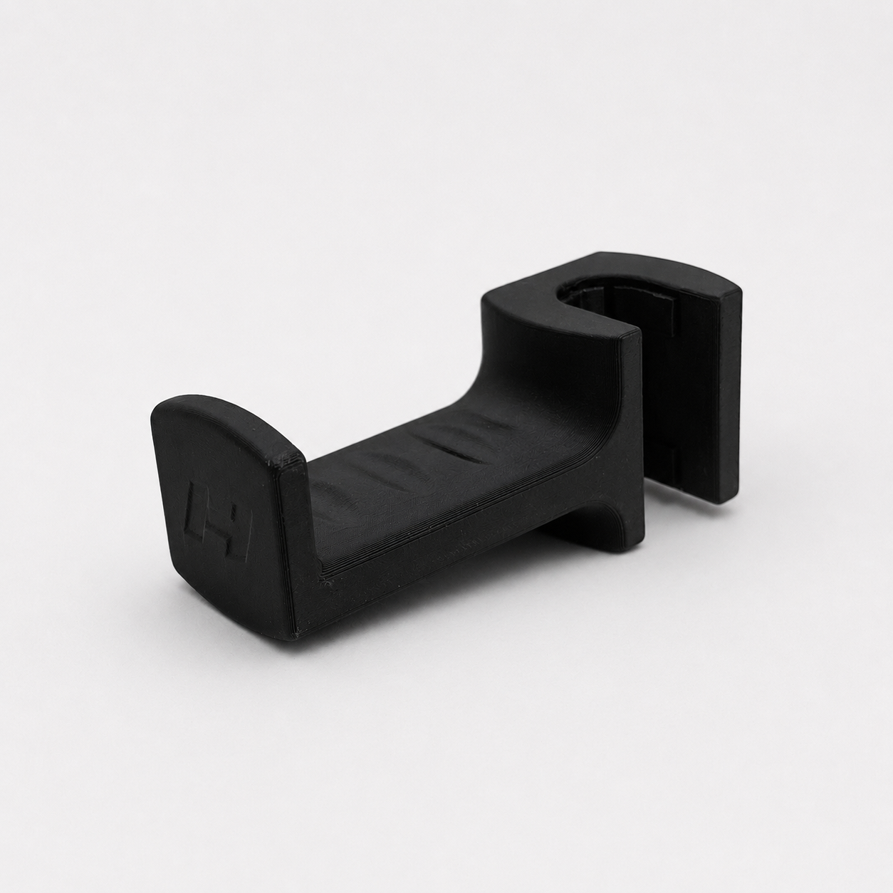 Black plastic headrest hook on a white background